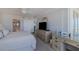 Inviting bedroom with a neutral color scheme, a dresser with a television, and a view into the en-suite bathroom at 4631 S Atlantic S Ave # 8201, Ponce Inlet, FL 32127