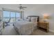 Bright bedroom featuring ocean views from the balcony, neutral decor, and a cozy seating area for relaxation at 4631 S Atlantic S Ave # 8201, Ponce Inlet, FL 32127