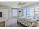 The bedroom showcases large windows, a ceiling fan, and beach-themed decorations at 4631 S Atlantic S Ave # 8201, Ponce Inlet, FL 32127