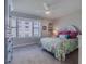Cozy bedroom with a ceiling fan, a large window view, and soft carpeting at 4631 S Atlantic S Ave # 8201, Ponce Inlet, FL 32127