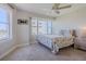 Relaxing bedroom featuring a ceiling fan, large windows, and plush carpeting at 4631 S Atlantic S Ave # 8201, Ponce Inlet, FL 32127