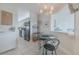 Charming dining area with a glass-top table and kitchen view at 4631 S Atlantic S Ave # 8201, Ponce Inlet, FL 32127