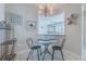 Cozy dining area with a glass table, stylish chairs, and decorative beach-themed accents at 4631 S Atlantic S Ave # 8201, Ponce Inlet, FL 32127