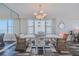 Dining room with stylish chairs, a decorative light fixture, and a unique accent wall mirror, enhancing the dining experience at 4631 S Atlantic S Ave # 8201, Ponce Inlet, FL 32127