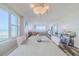 Bright dining area showcasing ocean views, a decorative chandelier and beach-themed accents throughout the open living space at 4631 S Atlantic S Ave # 8201, Ponce Inlet, FL 32127
