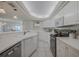 Open kitchen featuring white cabinetry, stainless steel appliances, and ample counter space for convenient meal preparation at 4631 S Atlantic S Ave # 8201, Ponce Inlet, FL 32127