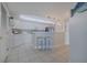 Bright kitchen featuring white cabinetry, counter seating, and modern appliances, perfect for casual dining and meal preparation at 4631 S Atlantic S Ave # 8201, Ponce Inlet, FL 32127