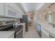 Efficient kitchen design with stainless steel appliances, white cabinets, and a view into the adjacent dining and living area at 4631 S Atlantic S Ave # 8201, Ponce Inlet, FL 32127