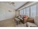 Bright living room with tile flooring, fan, shutters and comfortable seating at 4631 S Atlantic S Ave # 8201, Ponce Inlet, FL 32127