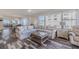 Comfortable living room with a large sectional sofa, glass coffee table and ocean views at 4631 S Atlantic S Ave # 8201, Ponce Inlet, FL 32127
