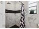 Bright bathroom featuring a decorative shower curtain, updated tile and niche for bath essentials at 480 Columbus Ave, Orange City, FL 32763