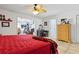 Airy bedroom featuring a ceiling fan, warm natural light, and adjoining access to an adjoining sun room at 480 Columbus Ave, Orange City, FL 32763