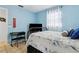 Light blue bedroom includes a tv, keyboard and window, creating a playful and cozy space at 480 Columbus Ave, Orange City, FL 32763