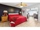 Bright bedroom featuring a striking black accent wall, ceiling fan, and seamless access to a sunroom at 480 Columbus Ave, Orange City, FL 32763