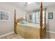 Bedroom features a traditional wooden four-poster bed, neutral walls, and a window with natural light at 480 Columbus Ave, Orange City, FL 32763