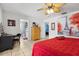 The bedroom features warm lighting, a vanity, ceiling fan, and adjoining bathroom at 480 Columbus Ave, Orange City, FL 32763