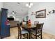 Dining area with a wooden table set for four, connects to the living room at 480 Columbus Ave, Orange City, FL 32763