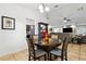 Cozy dining area featuring a round wood table and chairs, open to the living room and kitchen at 480 Columbus Ave, Orange City, FL 32763
