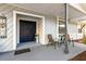 Covered entryway featuring seating, decor and a vibrant navy door at 480 Columbus Ave, Orange City, FL 32763
