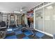 Functional home gym with equipment, motivating decor, ceiling fan, and sliding glass doors at 480 Columbus Ave, Orange City, FL 32763