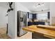 Updated kitchen features stainless steel appliances, butcher block countertops, and navy blue cabinetry at 480 Columbus Ave, Orange City, FL 32763