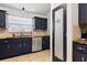 Kitchen with stainless steel appliances, wooden counters, beautiful backsplash and door to pantry at 480 Columbus Ave, Orange City, FL 32763