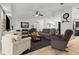 Open-concept living room with tile floors, neutral colors, and a view into the kitchen and dining areas at 480 Columbus Ave, Orange City, FL 32763