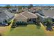 Aerial view of the home's backyard featuring a lawn and patio area at 5065 Nw 35Th Pl, Ocala, FL 34482