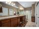 Spacious bathroom with double sinks, a large mirror, and a walk-in shower at 5065 Nw 35Th Pl, Ocala, FL 34482