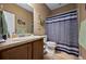 Bathroom with wood-look flooring, a sink and vanity, toilet, and shower with striped curtain at 5065 Nw 35Th Pl, Ocala, FL 34482
