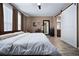 Bedroom with wood-look flooring, barn door access to the bathroom and natural light at 5065 Nw 35Th Pl, Ocala, FL 34482