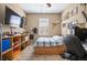 Bedroom with neutral walls and wood-look flooring, a bed, and a TV at 5065 Nw 35Th Pl, Ocala, FL 34482