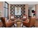 Inviting lounge area with leather chairs, a unique coffee table, and stylish brick and wood accents at 5065 Nw 35Th Pl, Ocala, FL 34482