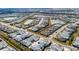 Bird's-eye view of a residential area featuring colorful houses, winding roads, and community lakes at 562 Landshark Blvd, Daytona Beach, FL 32124