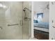Tile-walled shower with glass door and dual shower heads is positioned adjacent to an additional bedroom at 562 Landshark Blvd, Daytona Beach, FL 32124