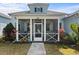 Charming home featuring a spacious screened-in front porch, stone walkway, and well-maintained landscaping at 562 Landshark Blvd, Daytona Beach, FL 32124
