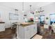 Spacious kitchen island with seating, granite countertops, and an open layout leading to the dining area at 562 Landshark Blvd, Daytona Beach, FL 32124