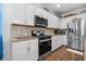 Well-equipped kitchen featuring stainless steel appliances, granite countertops, and ample cabinet space at 562 Landshark Blvd, Daytona Beach, FL 32124
