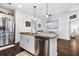 Modern kitchen island featuring granite countertops, stainless steel appliances, and seamless flow to the dining area at 562 Landshark Blvd, Daytona Beach, FL 32124