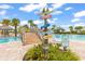 Beautiful pool area with themed signposts, landscaping, and lounge seating for an ideal vacation experience at 562 Landshark Blvd, Daytona Beach, FL 32124