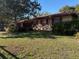 A well maintained single story home with lush lawn and red shutters on the windows at 575 Lantern Ln, Orange City, FL 32763