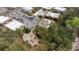 Aerial view featuring condo complex with community pool, picnic area, and ample parking at 600 N Boundary Ave # 115D, Deland, FL 32720