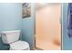Bright bathroom with a toilet and a tiled shower featuring a frosted sliding glass door at 600 N Boundary Ave # 115D, Deland, FL 32720