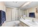 Cozy bathroom featuring a tub with sliding glass doors and a vanity with sink at 600 N Boundary Ave # 115D, Deland, FL 32720