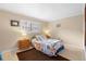 Cozy bedroom featuring a twin bed, wood floors, and a window with blinds for natural light at 600 N Boundary Ave # 115D, Deland, FL 32720