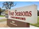 Four Seasons Condominiums community sign on a sunny day at 600 N Boundary Ave # 115D, Deland, FL 32720