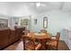 Dining room featuring a wooden table with four upholstered chairs and view to living room at 600 N Boundary Ave # 115D, Deland, FL 32720