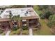 Aerial view of a brown two-story condo building with well-kept landscaping at 600 N Boundary Ave # 115D, Deland, FL 32720