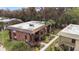 Two-story condo featuring brown siding, a flat roof, and well-maintained landscaping at 600 N Boundary Ave # 115D, Deland, FL 32720