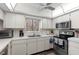 Bright kitchen features white cabinets, modern appliances, and a window above the sink at 600 N Boundary Ave # 115D, Deland, FL 32720